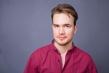 Studio portrait of young man on a dark background