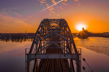 A view of the Railway Bridge over Daugava River during Sunset in Riga, Latvia