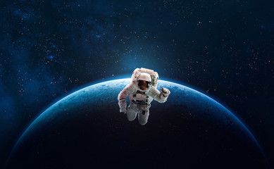 Obraz na płótnie Canvas Astronaut on orbit of Earth planet in the outer space. Abstract wallpaper. Spaceman. Elements of this image furnished by NASA 