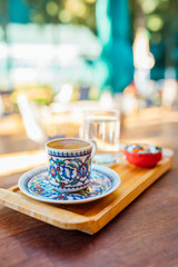 Traditional delicious turkish coffee on wooden table in cafe or restaurant