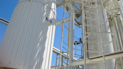 Technological columns of oil refinery.