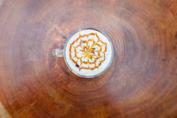 Latte coffee and cake on wooden table at outdoor