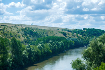 Obraz na płótnie Canvas Countryside natural panoramic landscape with river and hills on clear summer sunny day