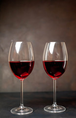 Glasses with red wine on a stone background