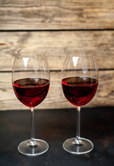 Glasses with red wine on a stone background