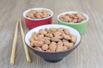 Almond nut on wood background.