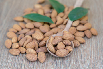 Almond nut on wood background.