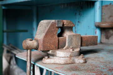 bench vise tool on metal workbench, vice grip on metallic table, professional clamp construction in workshop