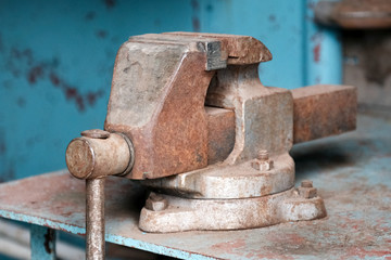 bench vise tool on metal workbench, vice grip on metallic table, professional clamp construction in workshop