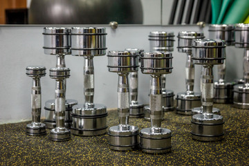 empty gym for fitness and bodybuilding with fitness equipment and dumbbells.