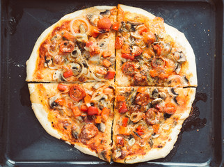 Home made pizza with shallow depth of field. Vintage style and instagram filter.
