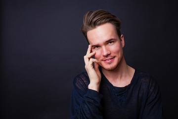 Studio portrait of young man on a dark background