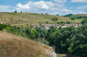 Countryside natural panoramic landscape with river and hills on clear summer sunny day