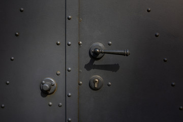 Closeup shot of a metal door with handle and lock