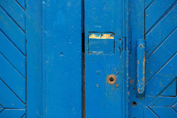 Closeup shot of old painted blue door outside. Copy space
