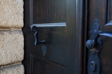 Closeup shot of forged handles on a wooden door