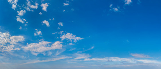 Panorama of peaceful blue sky with puffy white clouds. High resolution panoramic sky