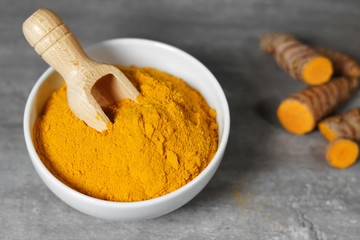 Turmeric Powder Bowl And Roots