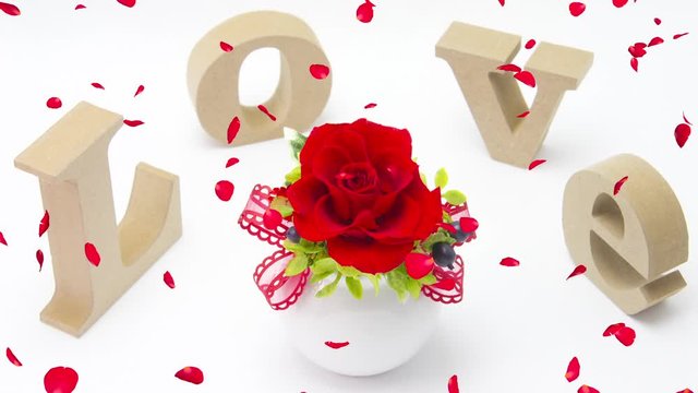 LOVE文字と薔薇に舞い散る花びら合成イメージ