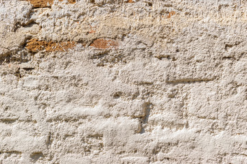 old stone wall of adobe bricks and mud