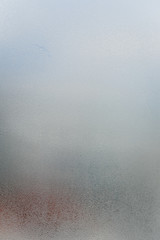 Close up on condensated water foggy window glass natural textured background.