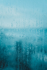 Close up on condensated water foggy window glass natural textured background.