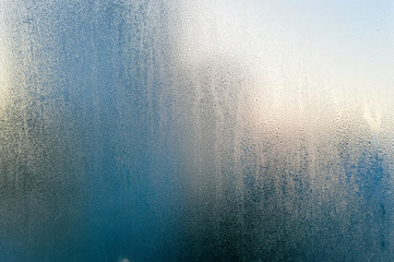 Close up on condensated water foggy window glass natural textured background.
