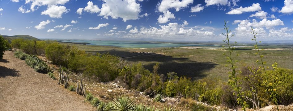 Wide Panoramic Landscape View of Guantanamo Bay, Cuba from Tourist Viewpoint above Cuban Naval Base while US base is distant on the horizon