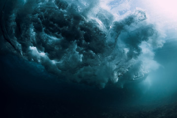 Wave underwater with bubbles. Ocean in underwater