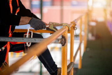 Construction worker wearing safety harness and safety line