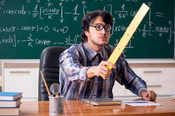 Funny male math teacher in the classroom 