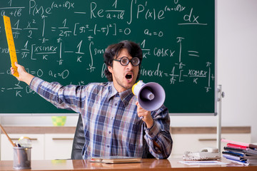 Funny male math teacher in the classroom 