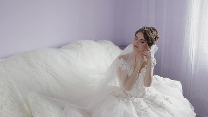 Beautiful and lovely bride in wedding dress. Wedding morning. Pretty and well-groomed woman. Slow motion