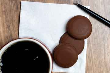 Coffee mug , cookies, pen and napkin with text space 