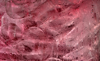 Ice cube in pink soft drink