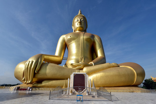 Big sitting Buddha image with blue sky cloud
