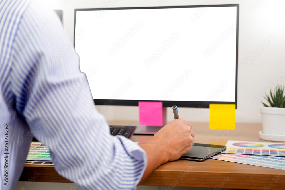 Aufkleber designer editor at work drawing sketches a new project on graphic tablet and color palette sitting a