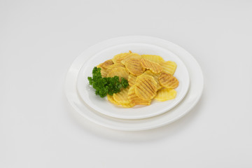 Potato chips in a plate isolated on white background