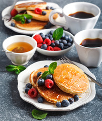 Pancakes with berries and honey.