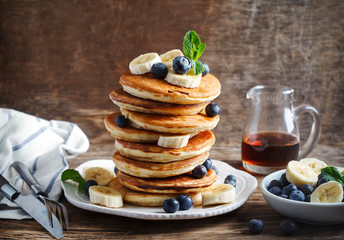 Pancakes with banana, blueberry and maple syrup for breakfast