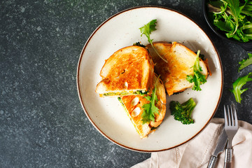 Broccoli and cheddar cheese sandwiches on plate