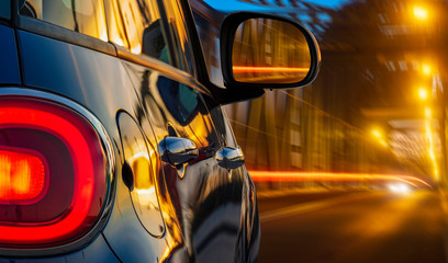 car driving at night on a lighted bridge