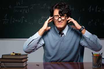 Young math teacher in front of chalkboard
