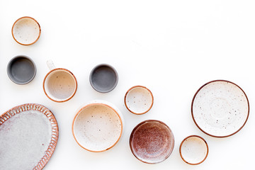 Ceramic tableware pattern. Empty plates and mugs on white background top view space for text