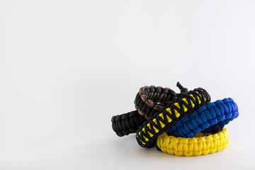 pile of paracord bracelets on a blank white background
