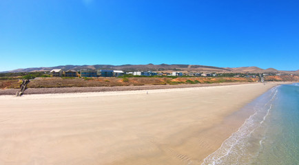Drone aerial view of Australian wide open beach and coastline, taken at Sellicks Beach, South Australia.