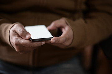 Close-up of man using mobile phone. smart phone showing blank screen for display montage