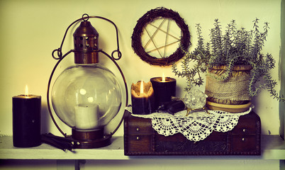 Old lamp, burning black candles, succulent plant, wooden box and pentagram. Magic gothic ritual....