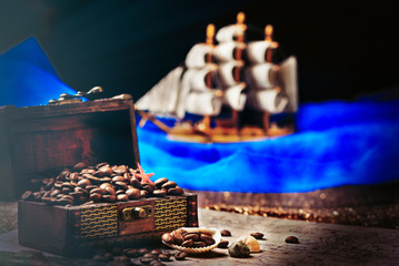 Image of middle-aged coffee beans. Poured into a pirate chest. Precious, expensive, tonic, invigorating, fragrant, delicious, high-quality, roasted drink. Brown, glossy grains.