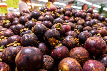 Fresh organic exotic fruit mangosteen on a local food market, Bali island. Mangosteen background.